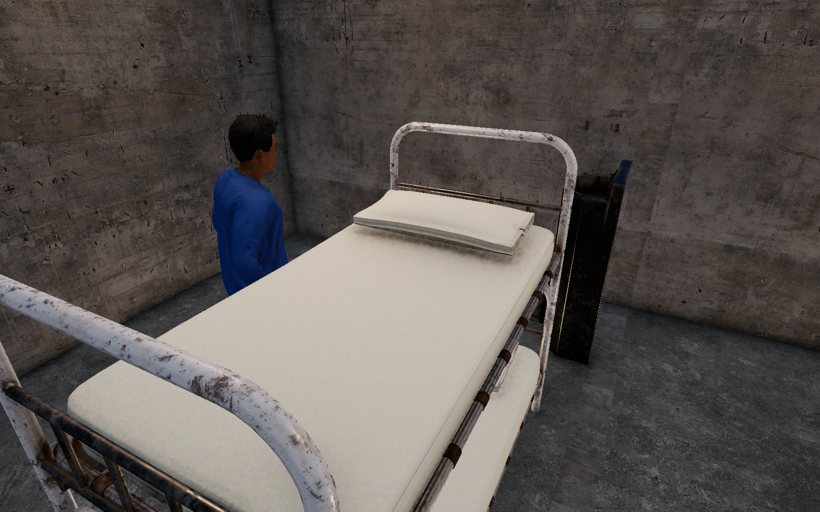 An in-game development view of a prison cell, with fitted bunk bedding and a prisoner beside the bed